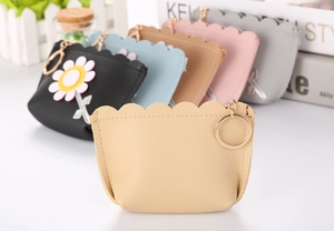 Detailed view of colorful scalloped PU leather coin purses with metallic key rings