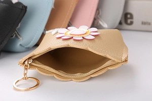 Detail of champagne gold PU leather coin purse showing zipper interior and daisy pattern