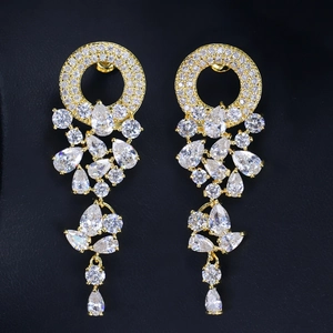 Sparkling AAA zircon garland drop earrings in gold finish on black leather background