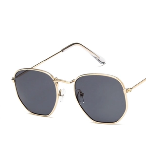 Modern hexagonal gold metal sunglasses with dark gray lenses for a retro fashion look