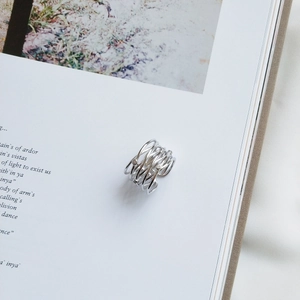Detailed view of S925 sterling silver multilayer ring with sparkling rhinestones on book