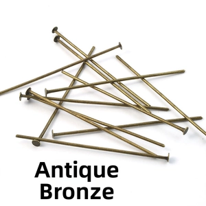 Close-up of antique bronze metal flat head pins for DIY jewelry making and beading