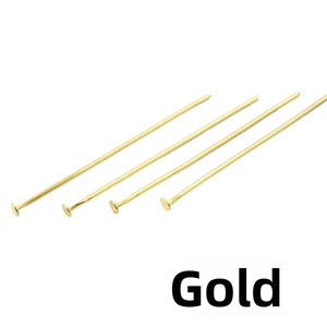 Macro shot of gold-plated flat head pins for DIY jewelry making and beading projects