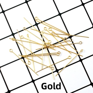 Detailed view of gold jewelry headpins for DIY beading and handmade craft accessories