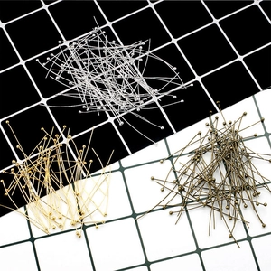 Macro shot of silver, gold and bronze metal ball head pins for DIY jewelry making