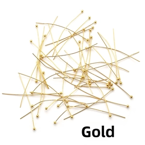 Macro detail of gold plated ball head pins for jewelry making and DIY crafts