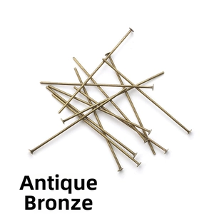 Macro detail of bronze flat head pins for DIY jewelry making and handmade beadwork crafts