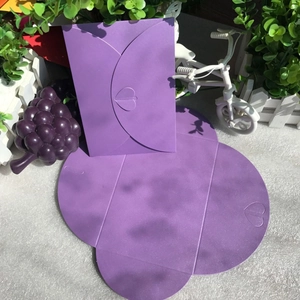Detail of purple pearlescent envelope with heart-shaped buckle and flat unfolded view