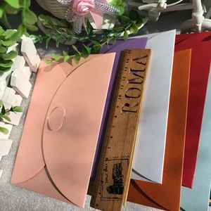 Macro view of assorted pearlescent envelopes with heart-shaped clasps in many colors