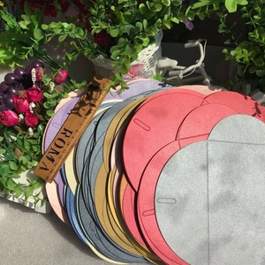 Close-up of premium pearlescent envelopes with heart buckles in multiple metallic colors