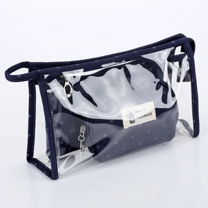 Detail of transparent PVC makeup bag with dark blue trim and inner crown print pouch