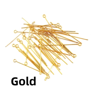Macro detail of gold eye pins for DIY jewelry making and beaded accessory crafting