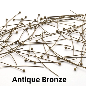 Macro shot of antique bronze jewelry ball head pins for professional DIY beadwork crafting