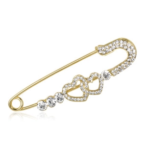 Detail of a gold safety pin brooch featuring sparkling rhinestones and double heart design