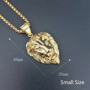 Detailed close-up of small size gold-plated lion head pendant with sparkling crystal eyes
