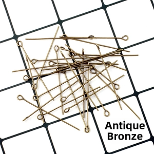 Close-up of antique bronze metal eye pins for DIY jewelry making and beading projects