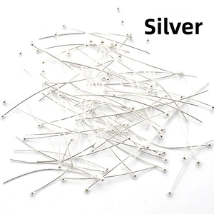 Macro shot of silver-plated ball head pins for professional DIY jewelry making and beading