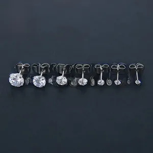 Row of seven round-cut cubic zirconia stud earrings in varied sizes with steel prong setting