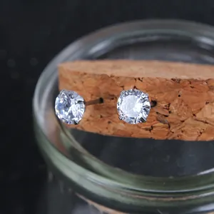 Macro view of round-cut cubic zirconia stud earrings with classic four-prong silver setting