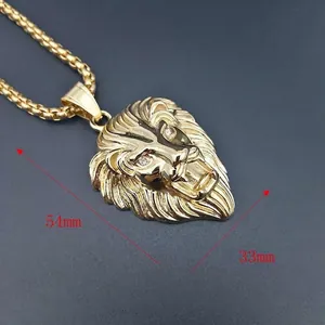 Detailed macro view of large gold-plated lion head pendant with crystal eyes and 54mm height