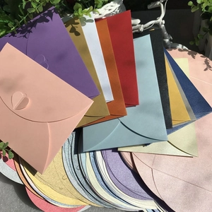 Macro shot of colorful pearlescent envelopes with unique heart-shaped closures and texture