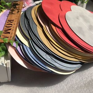 Macro shot of colorful pearlescent envelopes with heart-shaped clasps stacked in layers