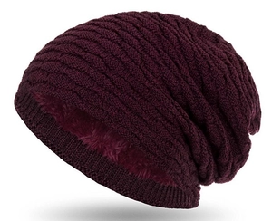 Detail view of burgundy knit beanie featuring warm thick inner fleece lining for winter