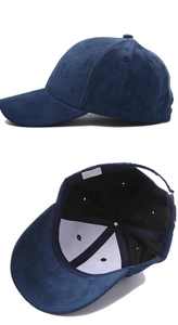 Detailed view of dark blue faux suede baseball cap showing interior polyester material tag