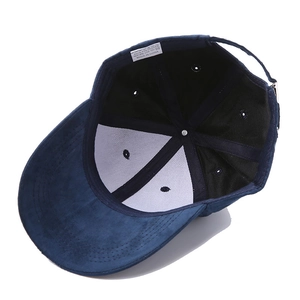 Deep blue faux suede baseball cap showing interior lining and polyester washing label