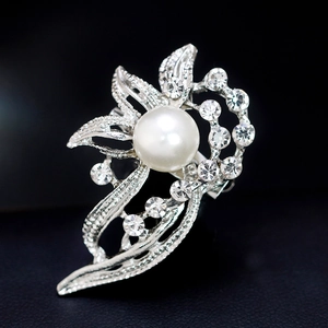 Elegant floral brooch with a large white pearl and crystals on silver metal petal base