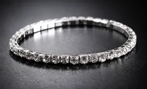 Detail shot of a silver elastic tennis bracelet featuring sparkling clear rhinestones