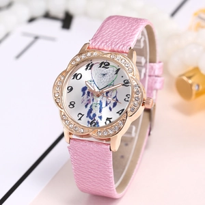 Close-up of pink leather strap watch with gold flower case and dreamcatcher dial