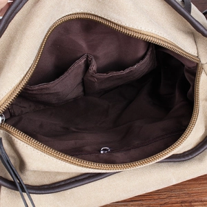 Canvas messenger bag interior view showing a zipper pocket and smooth dark lining