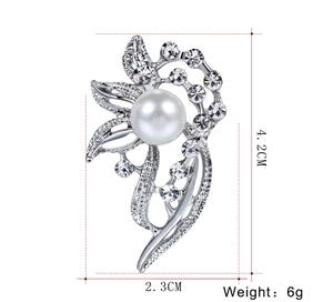 Macro detail of elegant silver brooch with white pearl and zircons, size 4.2cm by 2.3cm