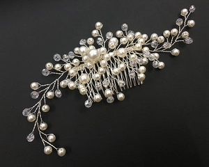 Detailed view of handmade bridal hair comb with pearls and crystals on silver wire