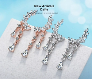 Detail of long floral drop earrings with rose gold and silver finish and zircon water drops