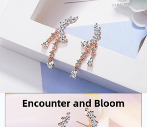 Detailed macro view of rose gold leaf earrings with zircon pave and pear-cut droplets