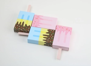 Detail of drawer-style candy boxes in ice cream popsicle shapes with colorful toppings