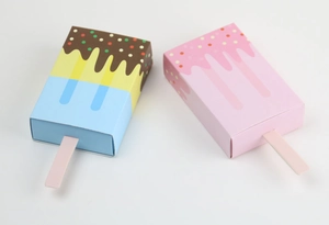 Detail of popsicle-shaped paper candy boxes with colorful sprinkles and cardboard handles