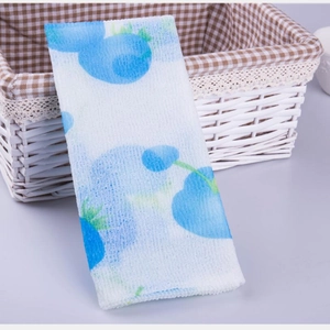 Exfoliating nylon back scrubber with blue berry print and coarse texture in a basket