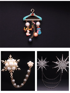 Detailed views of Christmas brooches with enamel charms, pearls, and starry rhinestones