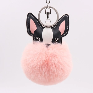 Detail of cute puppy PU leather head with a large fluffy pink pompom keychain