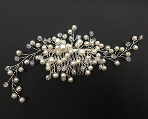 Detail of handcrafted bridal hair comb with pearls and crystals on silver wire