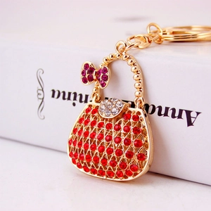 Luxury rhinestone handbag keychain with red crystals and purple bow charm gold metal