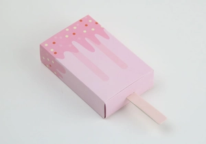 Detailed view of a pink popsicle-shaped candy box with creative melting drip design
