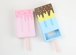 Close-up of pink and colorful ice cream shaped drawer paper candy boxes with sticks