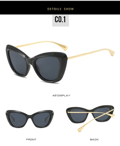 Detail view of cat-eye sunglasses with gold metal temples and polished black frames