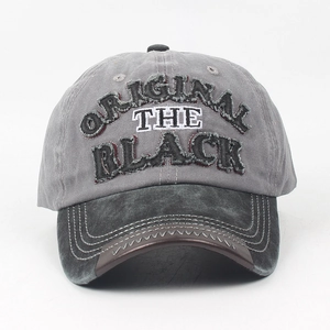 Close-up of vintage distressed embroidery and stitching on washed cotton baseball cap
