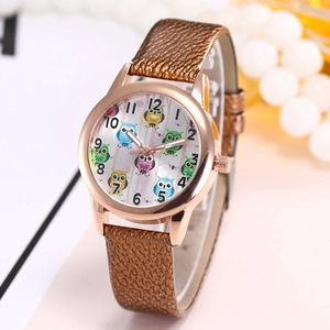 Detail of creative owl patterned dial on a ladies watch with brown leather strap