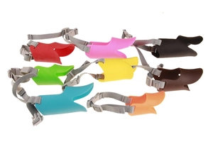 Detailed view of eight colorful silicone duck-billed muzzles for dogs on white background